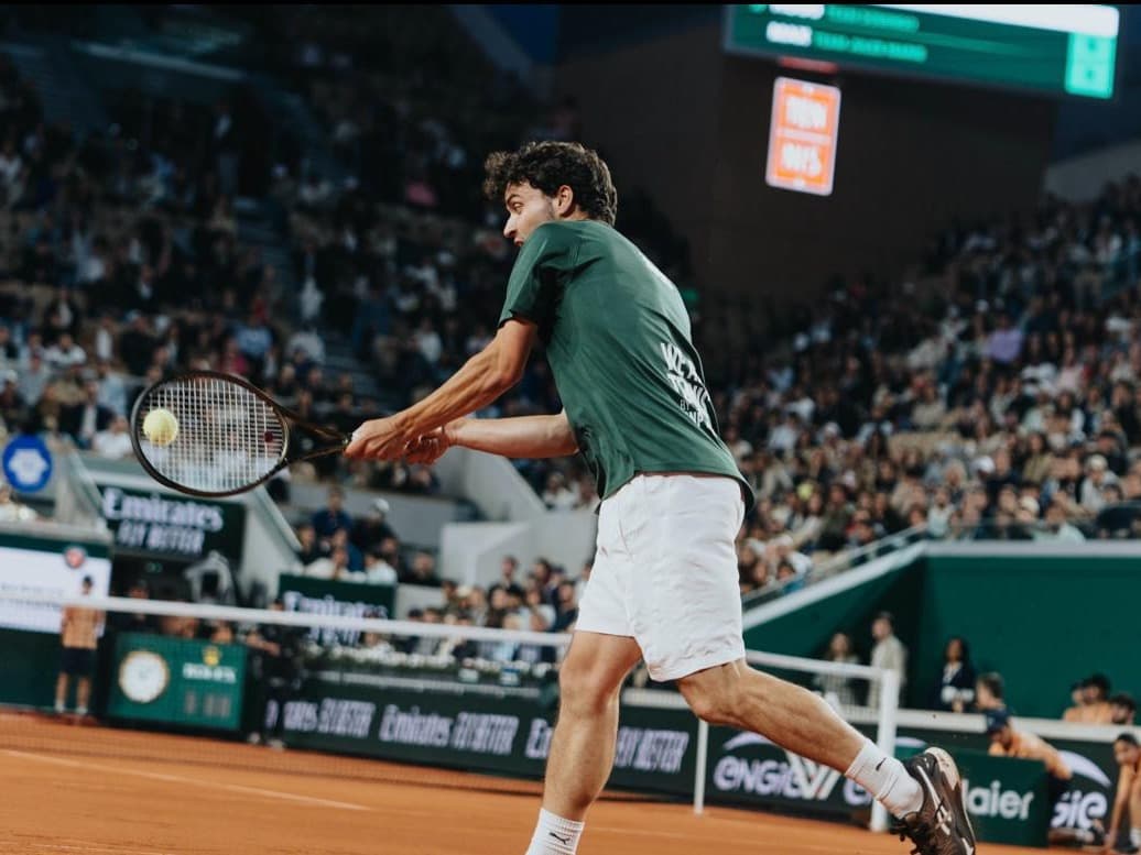 Joueur en plein revers à deux mains lors d'un match à Roland-Garros